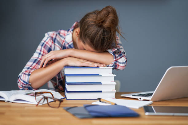 istock Tired female student learning till late at home 1200723745