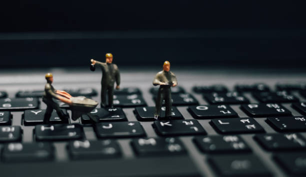 istock Soft focus is blurry. Miniature technicians working on laptop keyboard and computer maintenance. 1200724582