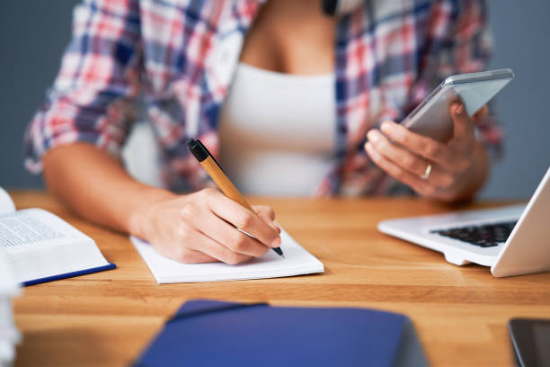 istock Midsection of female student learning at home 1200725169