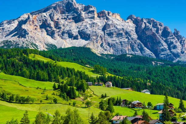 istock Green alpine meadows with huge mountains range on the background. 1200726486