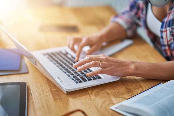 istock Midsection of female student learning at home 1200726594