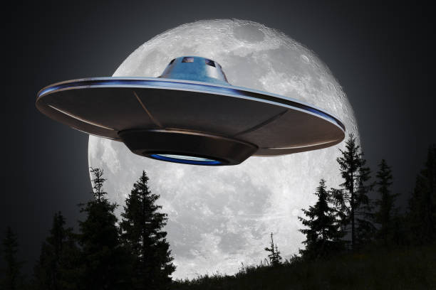istock Alien spaceship (UFO) is flying at night. Moon in background. 1200726834