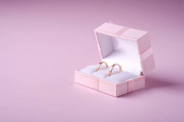 istock Wedding gold rings in pink gift box on soft pink background, angle view, copy space 1200727118