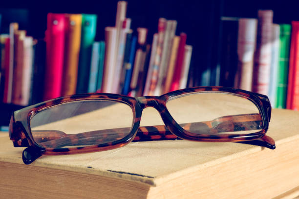 istock A pair of glasses, a book and the library 1200727355