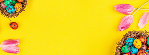istock Stylish background with colorful easter eggs isolated on yellow background with pink tulip flowers. Flat lay, top view, mockup, overhead, template 1200729414