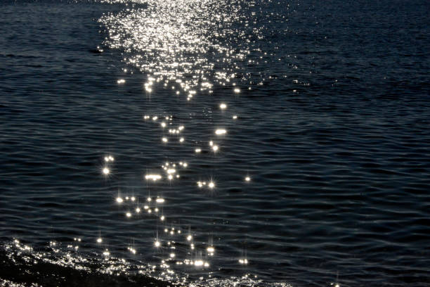 istock Sun reflection in the water, near the coast, at sunset 1200730087