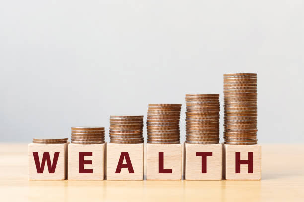 istock Money coins stack stair as step growing growth and wooden cube block with word WEALTH. Investment and save money concept 1200730396