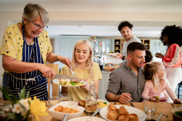 Roast Dinner is Ready! A front-view shot of a multi ethnic family ready to enjoy a roast dinner. roast dinner stock pictures, royalty-free photos & images