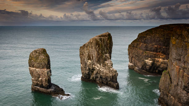 istock Sunrise at stack rocks on dramatic coast of Pembrokeshire, South Wales, UK 1200732152