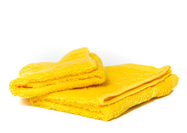 istock Yellow towels isolated on white 1200732289