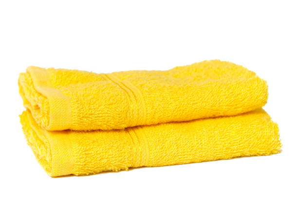 istock Yellow towels isolated on white 1200732333