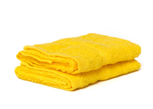istock Yellow towels isolated on white with copyspace 1200732400