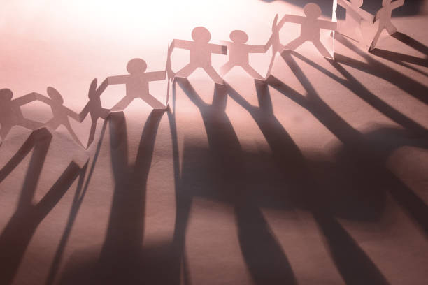 istock Silhouette paper in man shape hold hand together 1200733291
