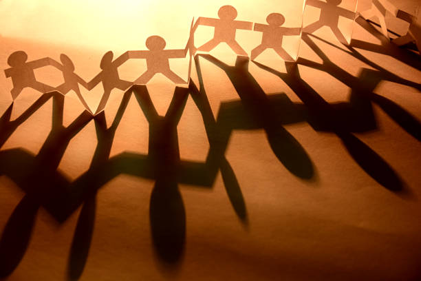 istock Silhouette paper in man shape hold hand together 1200733301