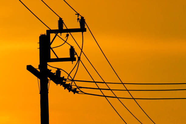 istock High-voltage tower at sky background,high voltage post at sky backgound, Silhouette of pylons,Electricity pylons and lines 1200733878