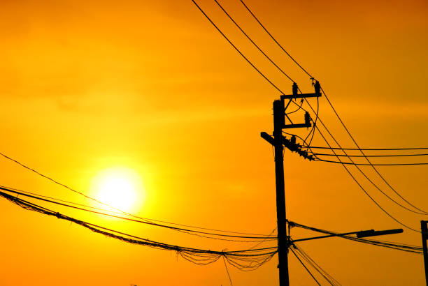 istock High-voltage tower at sky background,high voltage post at sky backgound, Silhouette of pylons,Electricity pylons and lines 1200733883