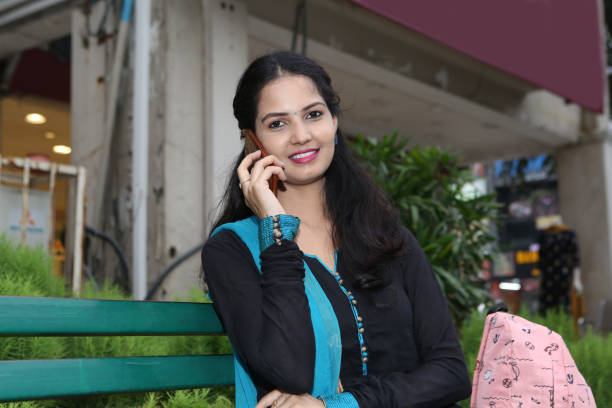 istock Indian Happy Woman talking on mobile. Using mobile. 1200734144