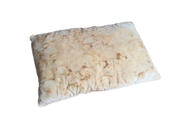 Old dirty pillow with saliva stain and fungus cause of illness stock photo