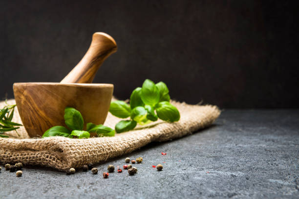 istock Mortar and pastle with fresh herbs for cooking 1200734542