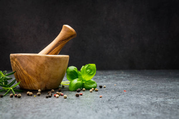 istock Mortar and pastle with fresh herbs for cooking 1200734686