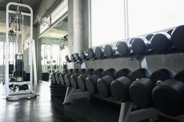 rows of dumbbells in the gym background for banner presentation. themes about exercise for good health. - themes imagens e fotografias de stock