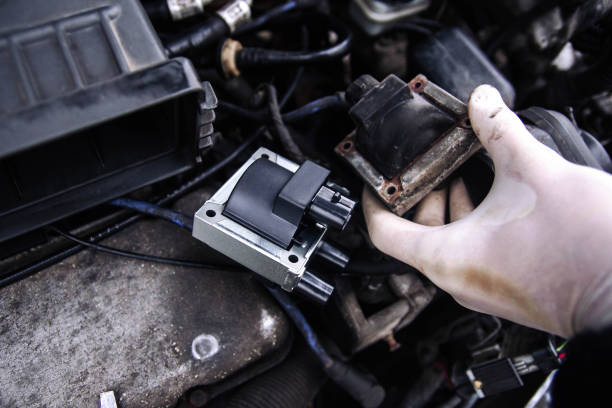 repair electricians ignition coils in a car, high-voltage wires. repair electricians ignition coils in a car, high-voltage wires. ignition photos stock pictures, royalty-free photos & images
