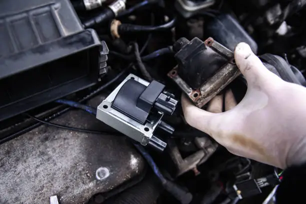 repair electricians ignition coils in a car, high-voltage wires.