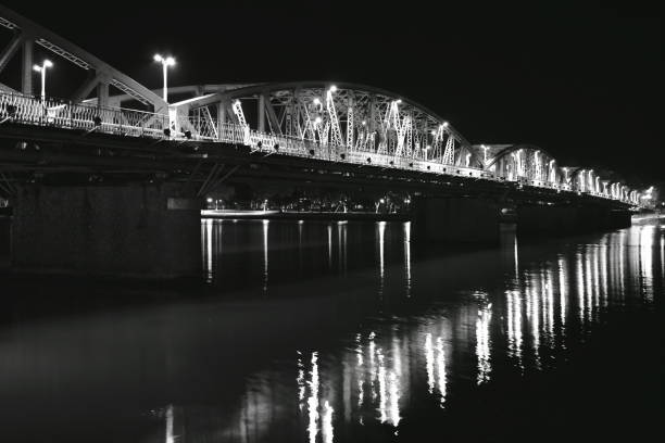 bridge cross river and reflection light bulb on the night in Vietnam
