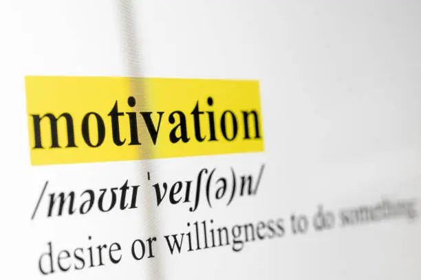 Highlighted text of "Motivation" with description and phonetic respelling. Selective focus and shot with macro lens from computer screen.