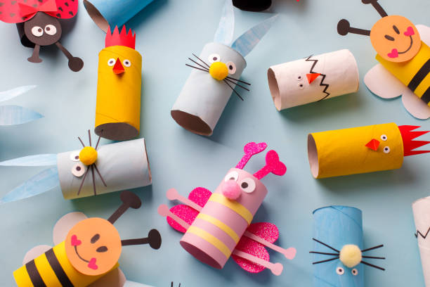 istock Happy easter kindergarten decoration concept - rabbit, chicken, egg, bee from toilet paper roll tube. Simple diy creative idea. Eco-friendly reuse recycle decor, daycare paper craft 1200740341