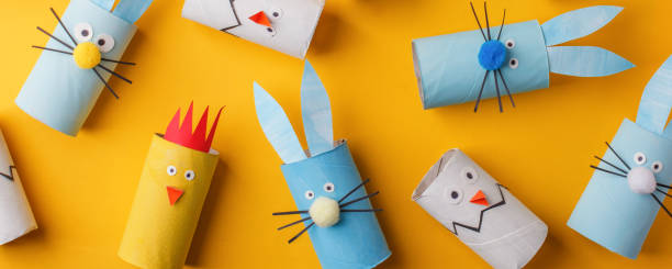 istock Happy easter kindergarten decoration concept - rabbit, chicken, egg, bee from toilet paper roll tube. Simple diy creative idea. Eco-friendly reuse recycle banner, daycare paper craft 1200740344