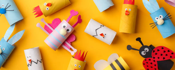 istock Happy easter kindergarten decoration concept - rabbit, chicken, egg, bee from toilet paper roll tube. Simple diy creative idea. Eco-friendly reuse recycle banner, daycare paper craft 1200740367