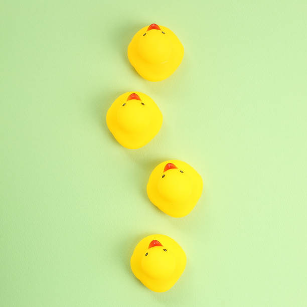 istock Yellow rubber duck doll on green background 1200741966