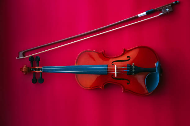 istock Violin and bow put on red background,the acoustic instrument 1200745114