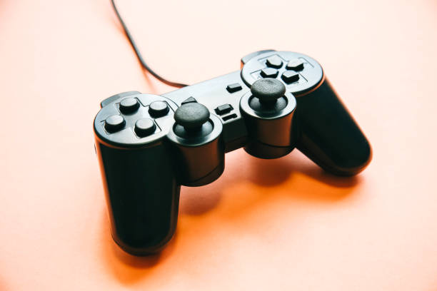 istock Joystick lying on the pink background. Gamepad for playing computer games. 1200746280