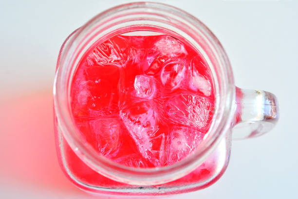 Red water and ice in clear glass