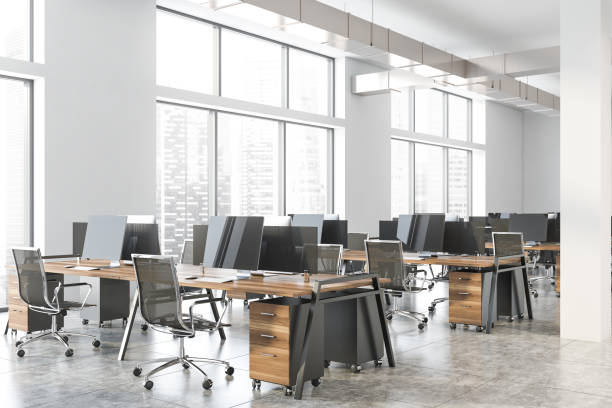 istock White industrial style office corner, wood tables 1200749234