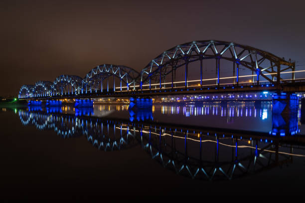 istock The Railway Bridge in Riga at night with train crossing the bridge 1200749918