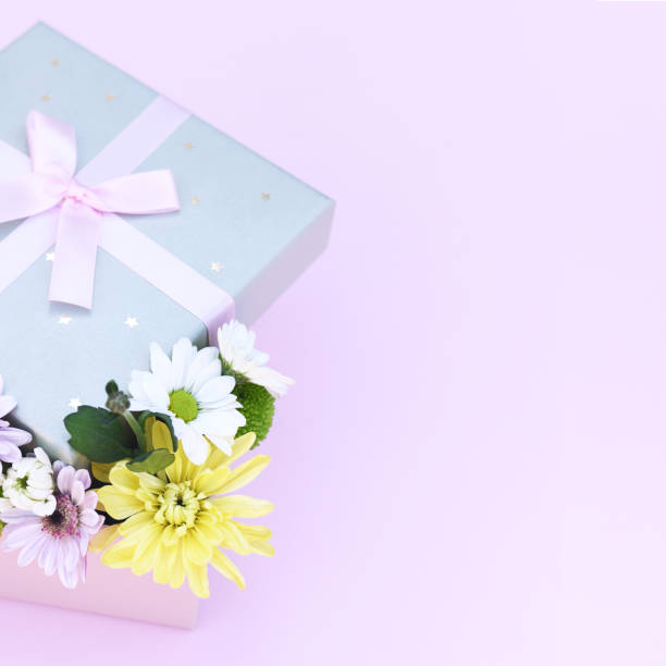 istock Delicate flower arrangement in a box on a pink background. 1200751409