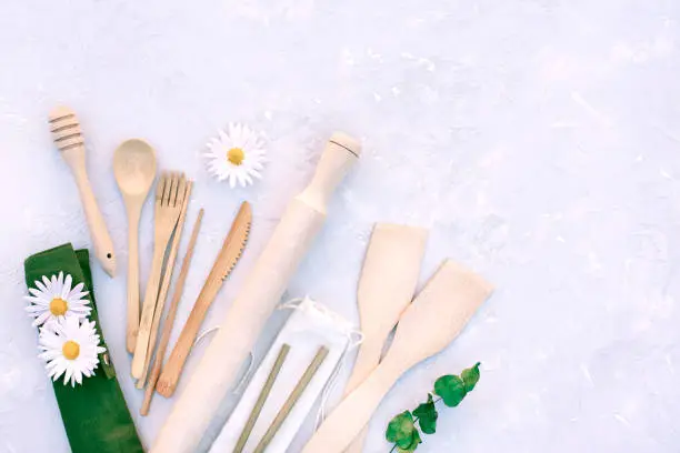 Photo of Ecological wooden set of kitchen appliances on a gray background.