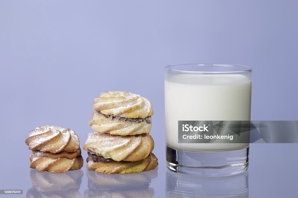 Cookies with milk Small group of cookies and milk glass  on a blue background Application Form Stock Photo
