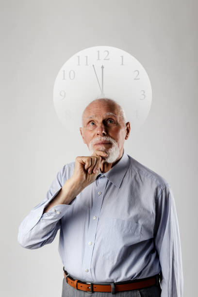 istock Old man and time. Old man is waiting. Three Minutes to Twelve. 1200754526