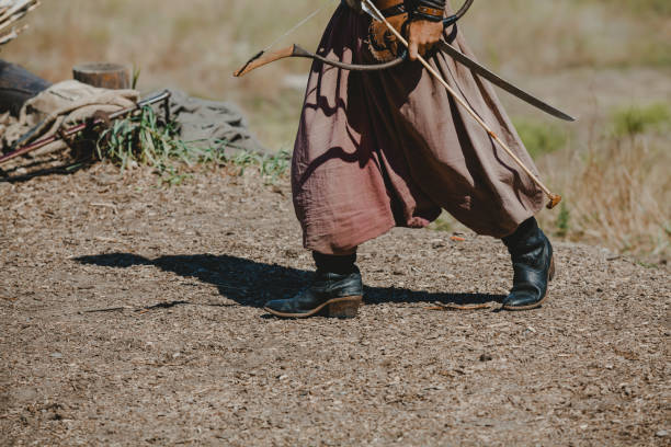 istock ancient warrior holds bow and arrow in his hands 1200754535