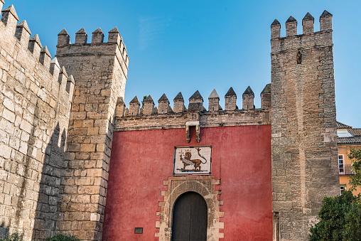 Seville, Spain – Sept 16, 2019: Lion Gate in the Royal Alcazar of Seville, Spain.\nThe Royal Alcazar gateway entrance in Seville, Spain