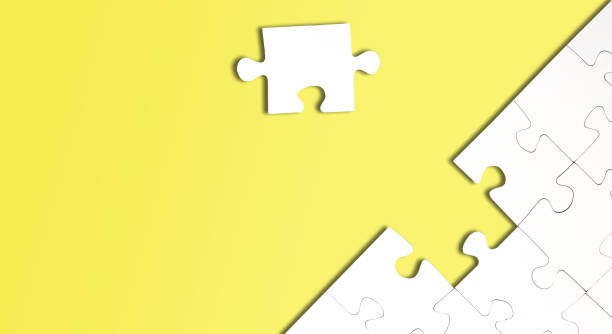 istock top view of jigsaw puzzle with one piece left on yellow background 1200757691