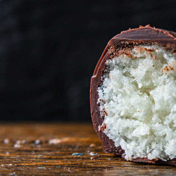 candy coconut in chocolate (tasty and healthy sweets dessert) menu concept. background. top view. copy space