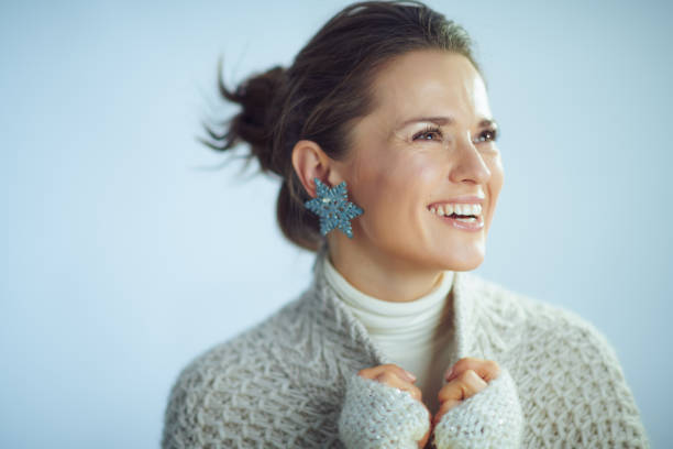 istock happy housewife with snowflake earring looking at copy space 1200758631