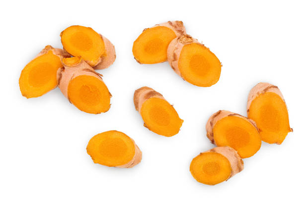 turmeric root slices isolated on white background. Top view. Flat lay.