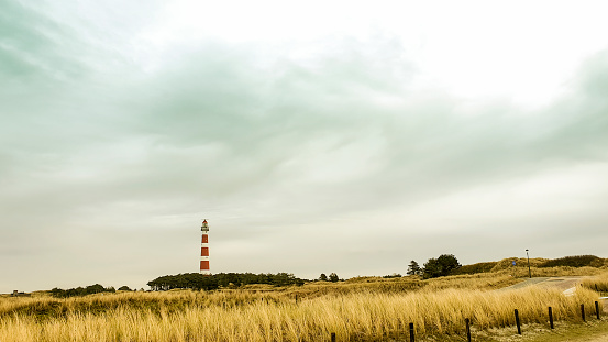 Ameland, Netherlands -  January 20, 2020: The red and white striped lighthouse on the Dutch island Ameland in the Wadden sea.
