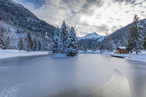 Very cold winter weather has frozen this French Alpine park lake